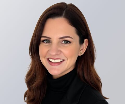 Danielle Easterday, Vcheck's SVP of Operations, against a gray background.