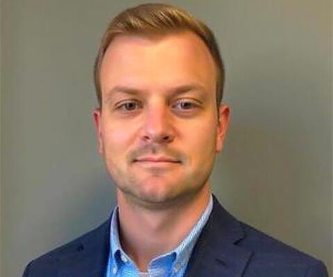 Vcheck's Chief Financial Officer Daniel Richard with a background.