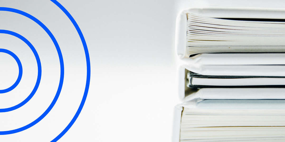 Three white binders filled with papers, representing the structured approach necessary for managing risks during account onboarding processes.