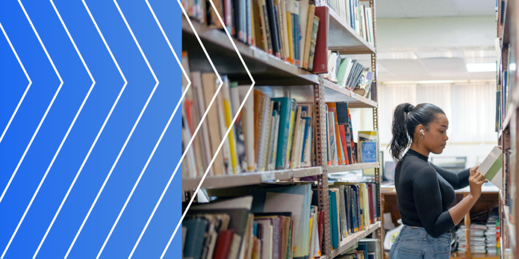 Woman searching for books in a library, representing the thorough research and due diligence necessary in higher education to support informed decision-making.