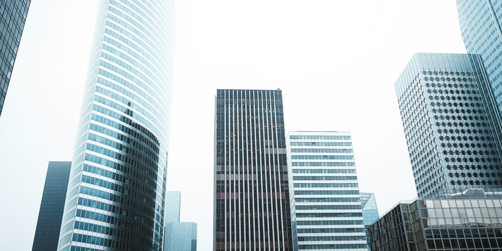 Buildings in a city clustered close together to represent the financial and reputational risk posed by complex business relationships