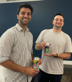 Two employees laugh at Vcheck's beer tasting event